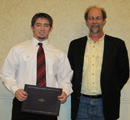 Kyle Steuber receives award from Dr. John Tomich