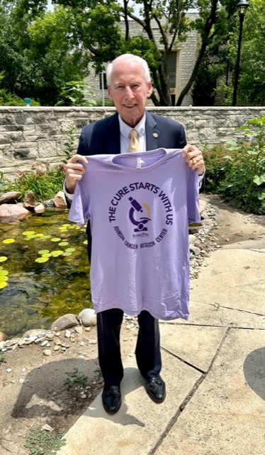 Bill Snyder holding tshirt