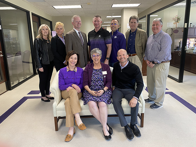 Cancer Center Advisory Council with men and women standing and sitting on a couch
