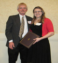 Dr. Eric Maata presents award to Colette Robinson