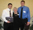 Jimmie Stewart & Jacob Hull receive award from Kay Fiser