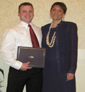 Joe Bloomfield receives award from Beverly Lueers