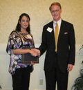 Nidia Ortega receives award from Jack Ryan