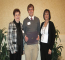 Almita & Carol Augustine present award to Sterling Braun