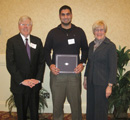 Faddy Khamis receives award from council members Mike & Elaine Jacobson.