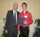 Luke Wenger receives award from center council member Albert Perry.