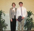 Charles Roach receives award from center council member Edie Dahlsten.