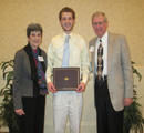 Alexander Noblett receives a award from Cibyl & Jim Ronen.