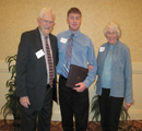 Christopher Larson receives an award from C. Clyde & Midge Jones.